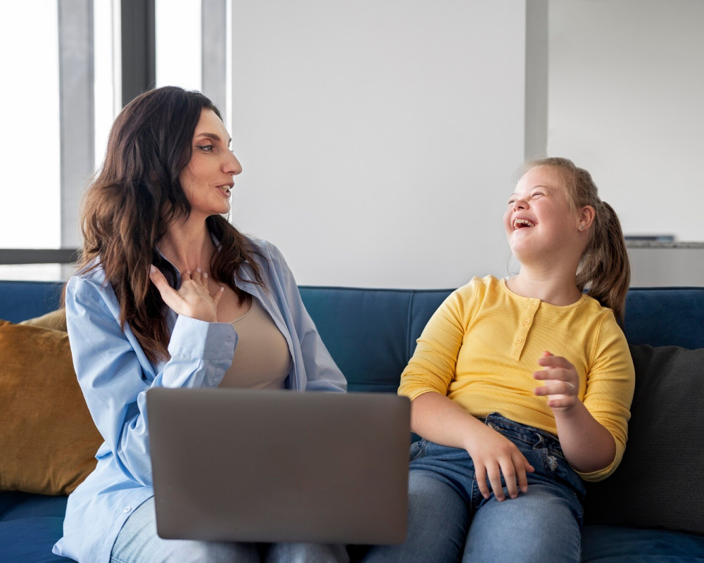 Smiling therapist talking with a happy young girl during an online therapy session at home